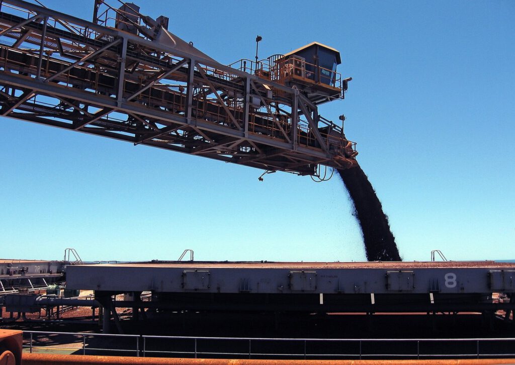 Shiploader loading bulk raw material onto a vessel at port